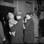 Passengers waiting to board a train in the concourse of the St. Paul Union Depot.