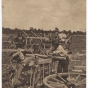 Black and white photograph of two men, probably Métis, preparing a Red River cart train at Pembina, 1856. 