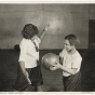 Black and white photograph of two girls playing basketball at Phyllis Wheatley House, ca. 1925.