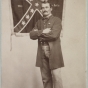 Marshall Sherman standing with the Twenty-eighth Virginia battle flag