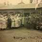 Black and white group photograph taken outside a Red Cross hut by Red Cross worker Julia Gray, 1919. 