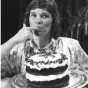 Black and white photograph of Bake-Off Grand Prize Winner Julie Konecne (Bemidji, MN) tasting her chocolate pecan praline layer cake, 1988.