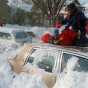 Color image of children playing on top of a car after the Halloween Blizzard, 1991. Photograph by Marlin Levison, Minneapolis Star Tribune. 