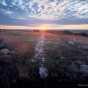 Color image of a sunrise during the autumnal equinox in Blue Mounds State Park, 1990.