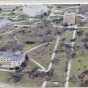 Color image of tornado damage in St. Peter, Minnesota, 1998. Image shows trees down and damage to a number of buildings. 