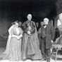 Black and white photograph of Mary T. and James J. Hill with Cardinal Vannutelli, a Papal delegate, on the Hill House veranda, 1910.