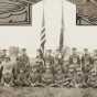 Black and white photograph of Minnesota Motor Corps officers and color guard at Camp Lakeview, Lake City, Minnesota, September, 1918. Motor Corps commander, Colonel Stephens, is kneeling left of the colors in the light colored tunic.