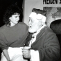 Dr. Rolland Dille, dressed as Santa Claus, with a student