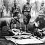 Black and white photograph of Candidates looking over United States Army kit at the Officers’ Training Camp, Fort Snelling, 1917. 