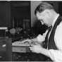 Photograph of a St. Paul Police worker revising police records