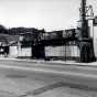 Black and white photograph of boarded-up storefronts on Plymouth Avenue in North Minneapolis, July 1967. Photographed by Twiggs.