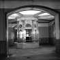 Black and white photograph of the flag case in the rotunda of the second capitol prior to demolition, 1937. Photographed by the Minneapolis Star Journal.