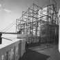 Black and white photograph of the Quadriga encased in scaffolding during application of gold leaf, 1979. Photographed by Elizabeth M. Hall.