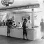 Black and white photograph of a Red Cross booth ("Let the Spirit of America Equal the Spirit of Belgium") at the 1917 Minnesota State Fair.