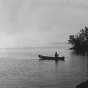 Black and white image of an individual canoeing on Lake Vermilion, 1935. 