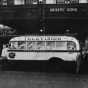 Black and white photograph of a Twin City Television Lab mobile unit in front of the Lyceum Theater and the Lab’s main entrance, c.1948.