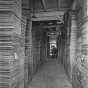 Black and white photograph showing stacks of milled lumber, ca. 1915.