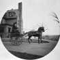 Black and white photograph of Rachael Hill in a horse-drawn buggy at the James J. Hill House, 240 Summit, St. Paul, 1898.