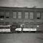 Black and white photograph of a 1872 horsecar compared to a new electric motor streetcar, May 3, 1921. Photographed by C.J. Hibbard.