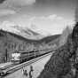 Black and white photograph of the Great Northern streamliner train in Glacier National Park, ca. 1955. Photograph by the Great Northern Railway.