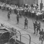 Black and white photograph of National Guard troops keeping a crowd back during a raid on strike headquarters in Minneapolis, 1934.