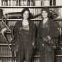 Black and white photograph of two women arrested by federal agents for making moonshine near St. Paul, 1921. Photographed by the St. Paul Daily News.