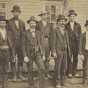 Black and white photograph of the six officials and volunteers, known as the “Madelia Seven,” who captured the Younger brothers outside Madelia on September 21, 1876.