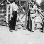 Black and white photograph of Harvey Fleshner with a Peterson farm employee outside the gates of the German prisoner of war camp, ca. 1943–1945.  Used with the permission of the Historical and Cultural Society of Clay County. 