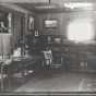 Black and white photograph of the living room of the Keck family home, ca. 1912.