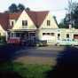 Color image of Lamb’s Resort, ca. 1957, after the inn was connected to old gas station, facing south. 