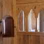 Color image of the leper’s window and part of the choir screen separating the chancel from the nave inside the Hopperstad Stave Church replica, April 2, 2017. Photographed by Kaci Johnson.