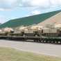 Color image of M1 Abrams tanks arrive at Camp Ripley on flatcars, 2015.  