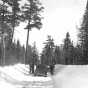 People standing around a car on the Gunflint Trail during winter. Photograph by Kenneth Melvin Wright, ca. 1944.