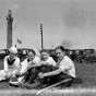 Group next to memorial tree planted on Victory Memorial Drive 