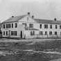 Black and white photograph of the Central House (where the Territorial Legislature met prior to the building of the State Capitol) and First State Capitol, St. Paul, ca. 1850.