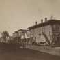 Black and white photograph of Division Street, Northfield 1870. The First National Bank is the first door to the left of the staircase. Photographed by Sumner’s Gallery.  