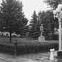 Black and white photograph of the statue of Leonidas Merritt in front of the public library in the town of Mountain Iron, 1940.