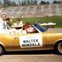 Senator Walter Mondale waves from the back of a car in the Minneapolis Aquatennial Parade, 1972