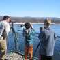 Color image of National Eagle Center visitors watch eagles from the center's observation deck, 2013.