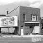 Boarded-up commercial building at 1418 Glenwood Avenue, ca. 1958. The image also shows a billboard advertising Wonder Bread. Photo by Norton & Peel.