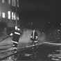 Black and white photograph of firefighters battling the flames in the Opera House Block in 1987.