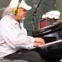 Longtime house pianist and music director Richard Dworsky plays during a live broadcast of A Prairie Home Companion at Macalester College in St. Paul, July 2015. Photograph by Wikimedia Commons user Jonathunder.