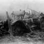 Black and white photograph of the ruins of a car after fire, Kettle River Road, 1918. 