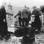 Black and white photograph of Red Cross workers serving meals to National Guard and survivors, Moose Lake forest fire, 1918.