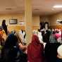 Color image of Somali women pray in the women’s prayer room at Dar Al-Hijrah during the holy month of Ramadan, 2013. 