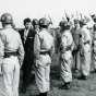 Black and white photograph of Governor Orville Freeman inspecting his troops at Camp Ripley, 1955.