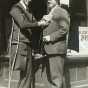 Black and white photograph of Congressman Melvin Maas (right) with a disabled constituent, 1930. 