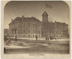 Black and white photograph of the first State Capitol building showing enlargement of 1878. Painted by Alfred Palmquist & Company, 1879.