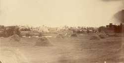 Black and white photograph of downtown Hanover seen from the Hennepin County side of the Crow River, ca. late 1800s.