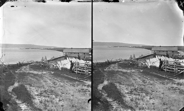 Black and white photograph of a view of La Pointe with Bayfield in the distance, 1875.